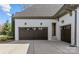 Spacious three-car garage with dark doors, ample driveway space, and well-maintained exterior at 2137 Foxcroft Woods Ln, Charlotte, NC 28211