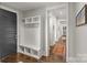 Inviting hallway with mudroom-style storage and hardwood flooring; well-lit with neutral color palette at 2137 Foxcroft Woods Ln, Charlotte, NC 28211