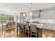 Bright, open kitchen featuring a large island with seating, modern appliances, and a dining area at 2137 Foxcroft Woods Ln, Charlotte, NC 28211