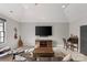 Relaxing living room featuring a ceiling fan, television, backyard view, and comfortable seating at 2137 Foxcroft Woods Ln, Charlotte, NC 28211