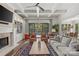 Inviting living room with a fireplace, coffered ceiling, and access to the outdoor patio and pool area at 2137 Foxcroft Woods Ln, Charlotte, NC 28211