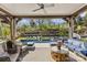 Expansive covered patio with comfortable seating area overlooking a stunning pool and landscaped backyard at 2137 Foxcroft Woods Ln, Charlotte, NC 28211