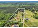Aerial view of the property with an approximate property line including house, outbuildings and wooded acreage at 2251 Old Applewood Ln # 9, Iron Station, NC 28080