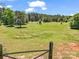 Beautiful expansive backyard with lush green grass, mature trees and gated area, perfect for animals or recreation at 2251 Old Applewood Ln # 9, Iron Station, NC 28080