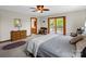 Bedroom featuring a ceiling fan, a dresser with a mirror, and sliding glass doors to the outside at 2251 Old Applewood Ln # 9, Iron Station, NC 28080