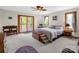 A large bedroom featuring a sitting area, windows and door to the outside, and neutral decor at 2251 Old Applewood Ln # 9, Iron Station, NC 28080