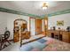 A comfortable bedroom featuring a traditional wood bed with patchwork quilt and vintage furniture at 2251 Old Applewood Ln # 9, Iron Station, NC 28080