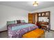 A light-filled bedroom with vintage wood desk, wood-frame bed, and soft natural light at 2251 Old Applewood Ln # 9, Iron Station, NC 28080