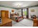 A cozy bedroom featuring a four poster bed, vintage furniture, and natural light from a window at 2251 Old Applewood Ln # 9, Iron Station, NC 28080