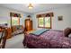 A comfortable bedroom with two bright windows, floral curtains, and vintage wooden furniture at 2251 Old Applewood Ln # 9, Iron Station, NC 28080