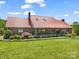 Charming brick home with a red metal roof, covered porch, and well-manicured lawn at 2251 Old Applewood Ln # 9, Iron Station, NC 28080
