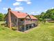 Brick house with a metal roof, chimneys, deck, walkout basement, and a spacious yard at 2251 Old Applewood Ln # 9, Iron Station, NC 28080