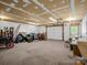Spacious garage area with ample space and a variety of equipment at 2251 Old Applewood Ln # 9, Iron Station, NC 28080