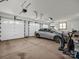 Spacious three-car garage with white doors featuring car and accessories at 2251 Old Applewood Ln # 9, Iron Station, NC 28080