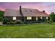 Exterior of a brick home with a metal roof, covered porch, and manicured lawn at 2251 Old Applewood Ln # 9, Iron Station, NC 28080