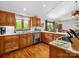 Well-lit kitchen featuring hardwood floors, wood cabinets, and a window overlooking the backyard at 2251 Old Applewood Ln # 9, Iron Station, NC 28080