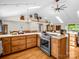 Spacious kitchen featuring stainless steel appliances, wood cabinets, an island, and skylights at 2251 Old Applewood Ln # 9, Iron Station, NC 28080
