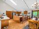 Bright kitchen featuring wood cabinets, an island, and an open layout to the dining area at 2251 Old Applewood Ln # 9, Iron Station, NC 28080