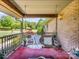 Covered front porch featuring a swing, decorative pillows, and a view of the front yard at 2251 Old Applewood Ln # 9, Iron Station, NC 28080