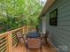 Wooden back deck surrounded by trees features an outdoor dining set at 2302 Jordi Way, Charlotte, NC 28213