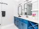 Bathroom with double sinks, modern fixtures, and blue vanity at 2302 Jordi Way, Charlotte, NC 28213