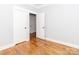 Bedroom with hardwood floors, white trim, doors and neutral walls at 2302 Jordi Way, Charlotte, NC 28213