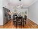 Dining area open to modern kitchen with stainless steel appliances and stylish light fixture at 2302 Jordi Way, Charlotte, NC 28213
