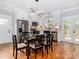 Dining area open to modern kitchen with stainless steel appliances and stylish light fixture at 2302 Jordi Way, Charlotte, NC 28213