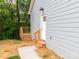 Side door entrance featuring wooden stairs and gray siding at 2302 Jordi Way, Charlotte, NC 28213