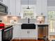 Stylish kitchen features white cabinets, a black farmhouse sink, and stainless steel appliances at 2302 Jordi Way, Charlotte, NC 28213