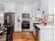 Bright kitchen featuring white cabinets, stainless steel appliances, and hardwood flooring at 2302 Jordi Way, Charlotte, NC 28213