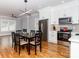 Open living space with hardwood floors, a dining area, and stainless steel appliances at 2302 Jordi Way, Charlotte, NC 28213