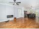 Open concept layout featuring hardwood floors, living room, dining area, and modern kitchen at 2302 Jordi Way, Charlotte, NC 28213