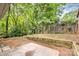 This backyard has a wooden fence line and wooden retaining wall at 248 Pangle Dr, Charlotte, NC 28217