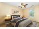 Staged bedroom features yellow walls, ceiling fan, bed and side tables with lamps at 248 Pangle Dr, Charlotte, NC 28217