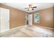 A bedroom needs renovation and features tan walls, a ceiling fan, and a window at 248 Pangle Dr, Charlotte, NC 28217