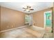 View of a bedroom with tan walls and a ceiling fan, ready for renovation at 248 Pangle Dr, Charlotte, NC 28217