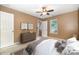 A staged bedroom features neutral decor, ceiling fan and a view of the front door at 248 Pangle Dr, Charlotte, NC 28217