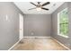 Bedroom with gray walls, ceiling fan, window, and carpet that needs replacing at 248 Pangle Dr, Charlotte, NC 28217