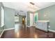 A dining area features a modern light fixture, hardwood floors and leads to entry and bathroom at 248 Pangle Dr, Charlotte, NC 28217