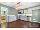 Modern kitchen with stainless steel appliances, white cabinetry, granite counters, and stylish lighting and a view into the bathroom at 248 Pangle Dr, Charlotte, NC 28217