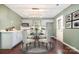 Charming eat-in kitchen with dining table, stainless steel appliances, white cabinetry and modern lighting at 248 Pangle Dr, Charlotte, NC 28217