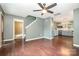 Spacious living room with hardwood floors, ceiling fan, staircase and eat-in kitchen in the background at 248 Pangle Dr, Charlotte, NC 28217