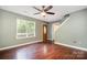 Inviting living room with hardwood floors, ceiling fan and natural light through a large window at 248 Pangle Dr, Charlotte, NC 28217
