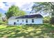 View of the back exterior with access to a large, green backyard and a patio area perfect for outdoor dining at 252 S Potter Rd, Lancaster, SC 29720