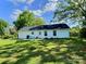 View of the home exterior with a spacious yard and a back patio with furniture at 252 S Potter Rd, Lancaster, SC 29720