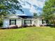 Charming single-story home with a well-maintained lawn, mature trees, and classic black shutters at 252 S Potter Rd, Lancaster, SC 29720