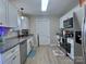 Well-lit kitchen with stainless steel appliances, granite countertops, and white cabinetry at 252 S Potter Rd, Lancaster, SC 29720