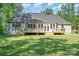 A spacious home has a large yard, deck, and multiple windows providing natural light at 2586 Lee Lawing Rd, Lincolnton, NC 28092