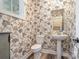 Charming powder room features floral wallpaper, pedestal sink, and a stylish mirror at 2586 Lee Lawing Rd, Lincolnton, NC 28092